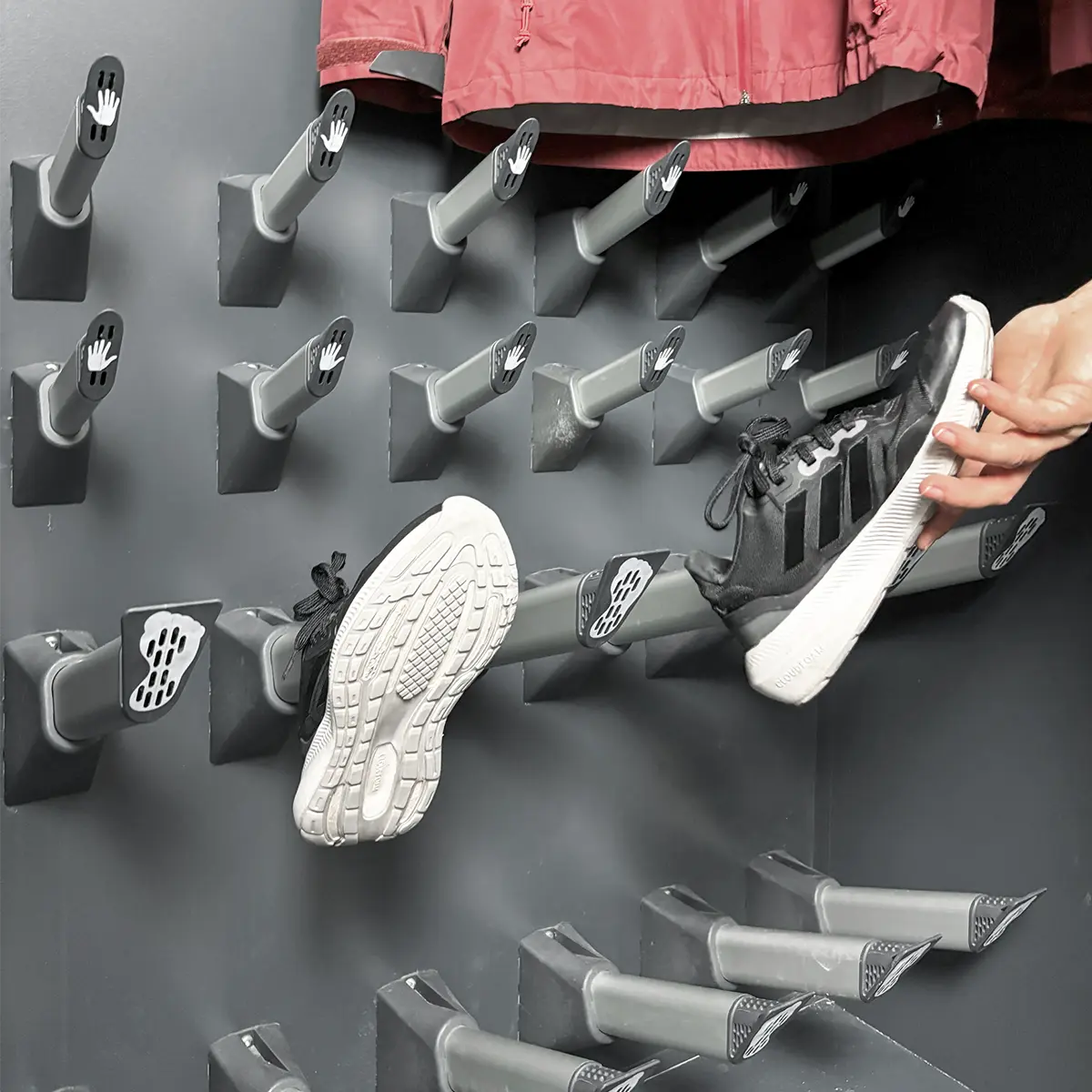 Employee hanging clothes into drying cabinet